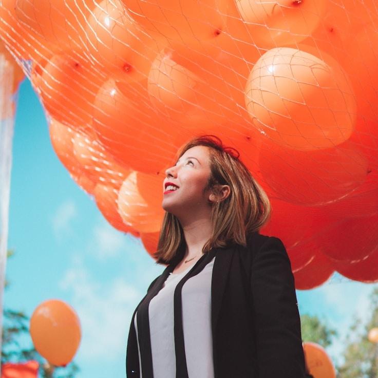 Kaveri Mehta, Lead Design Curator at BrookValeHarbor, reviewing corporate floral arrangements